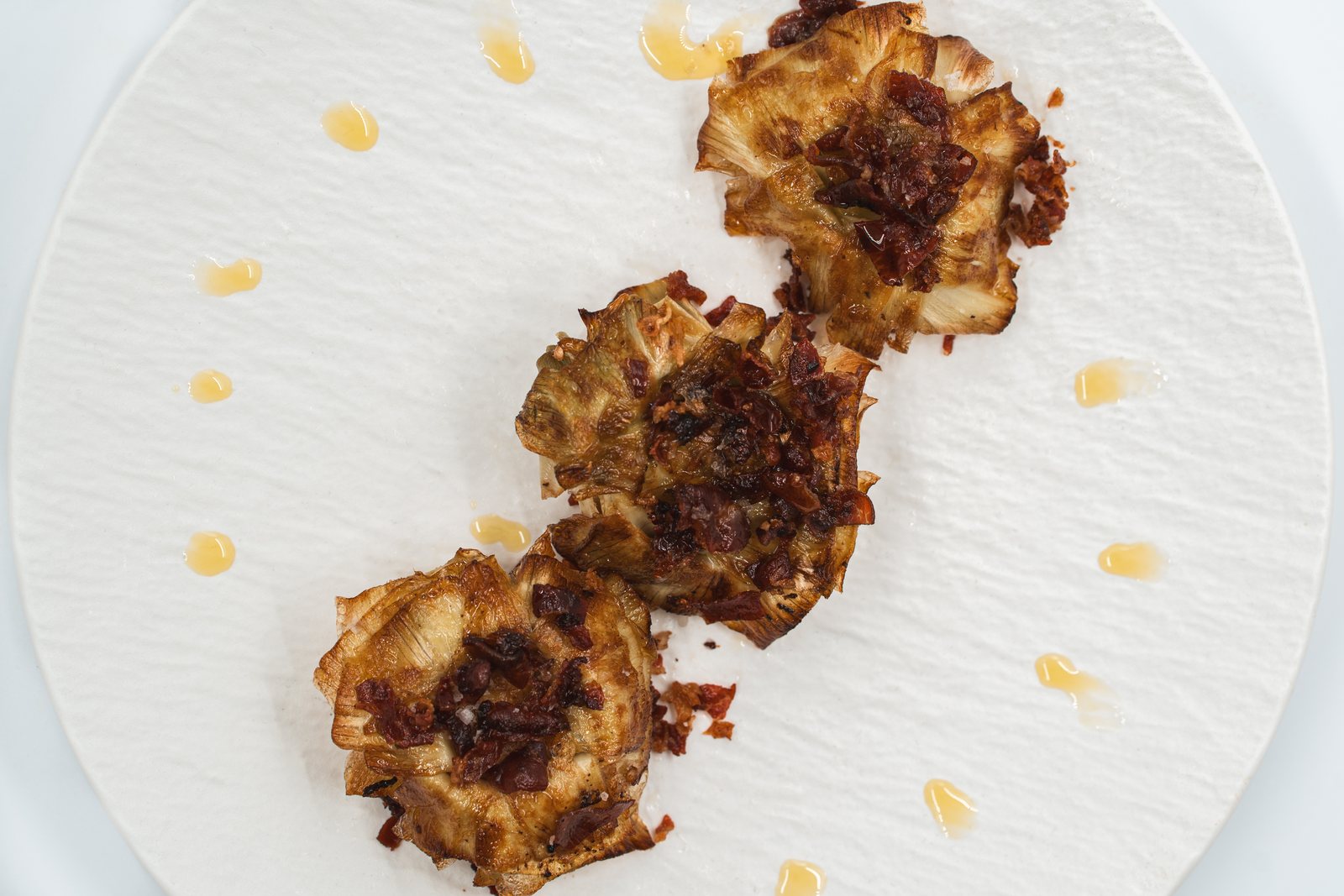 Confit artichokes with crisp jamón and honey